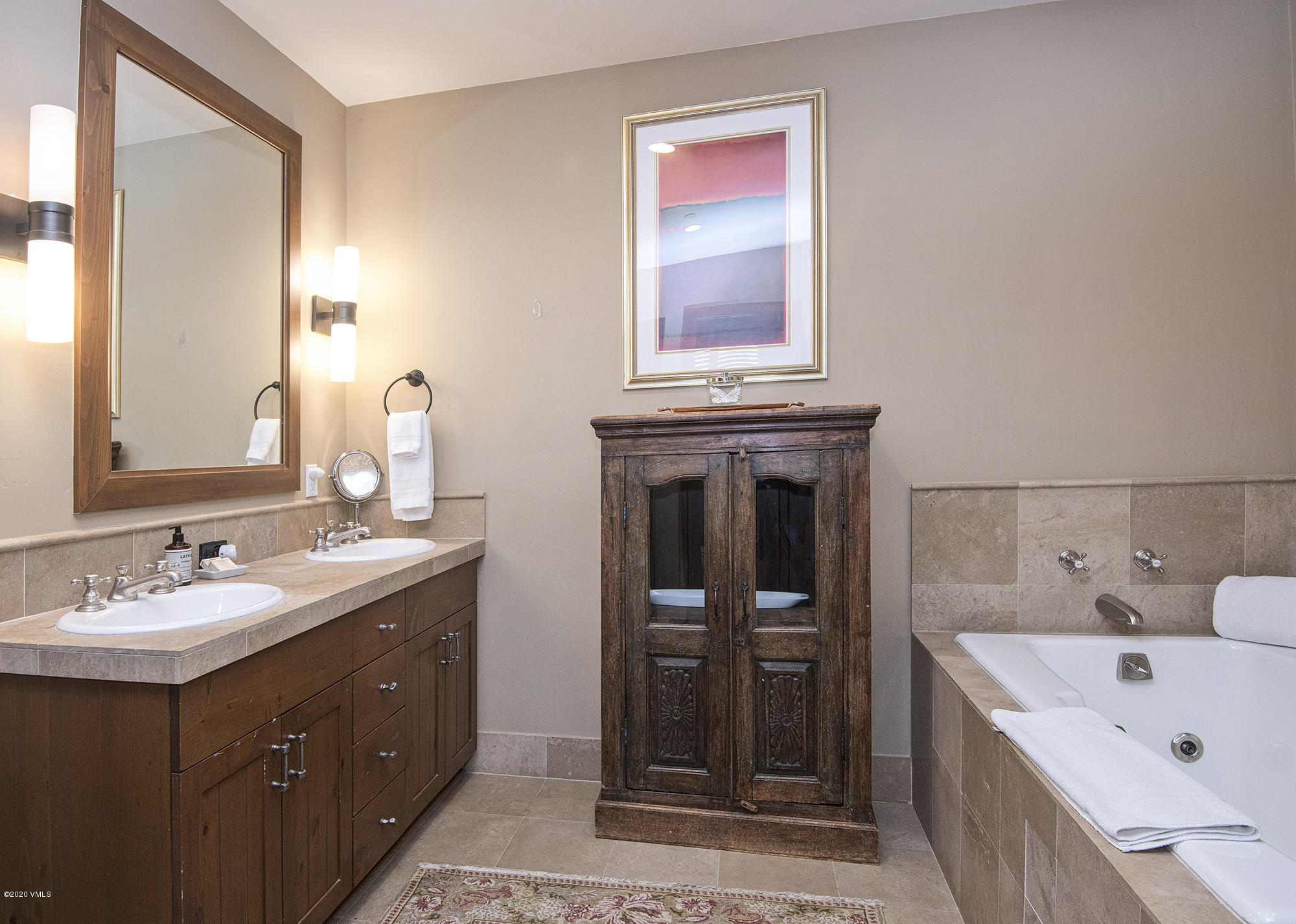 180 Daybreak Ridge Road, Unit 409 Avon, CO 81620 - Photo 20 of 47 a bathroom with a tub sink and mirror