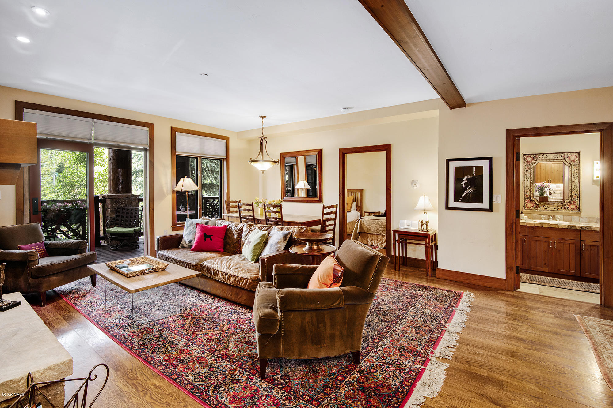 180 Daybreak Ridge Road, Unit 409 Avon, CO 81620 - Photo 2 of 47 a living room with furniture and wooden floor