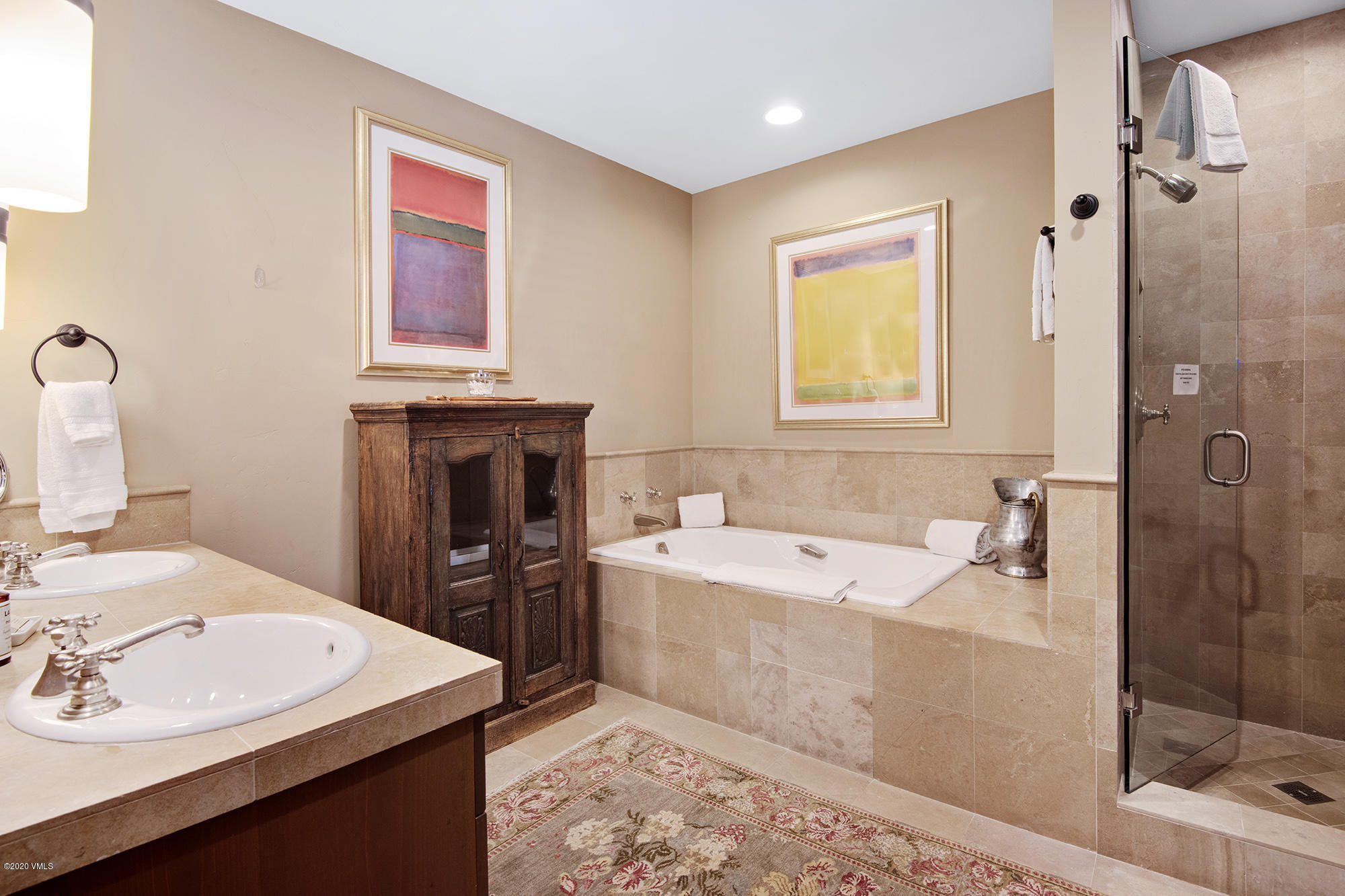 180 Daybreak Ridge Road, Unit 409 Avon, CO 81620 - Photo 21 of 47 a bathroom with a sink tub shower and a mirror