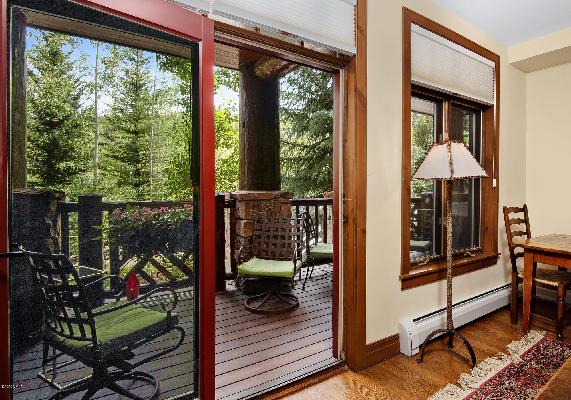 180 Daybreak Ridge Road, Unit 409 Avon, CO 81620 - Photo 24 of 47 a view of a balcony with chairs and wooden floor