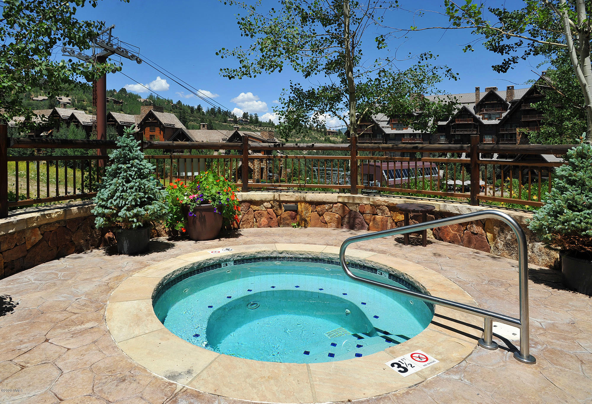 180 Daybreak Ridge Road, Unit 409 Avon, CO 81620 - Photo 30 of 47 a view of swimming pool with outdoor seating and plants