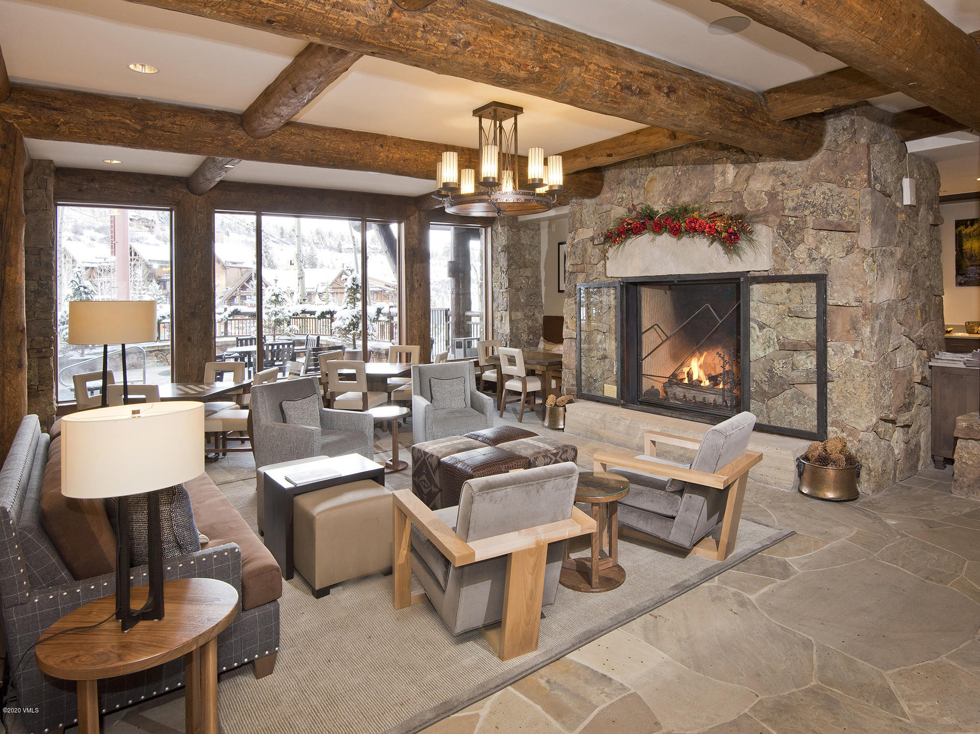 180 Daybreak Ridge Road, Unit 409 Avon, CO 81620 - Photo 31 of 47 a living room with fireplace furniture and a large window