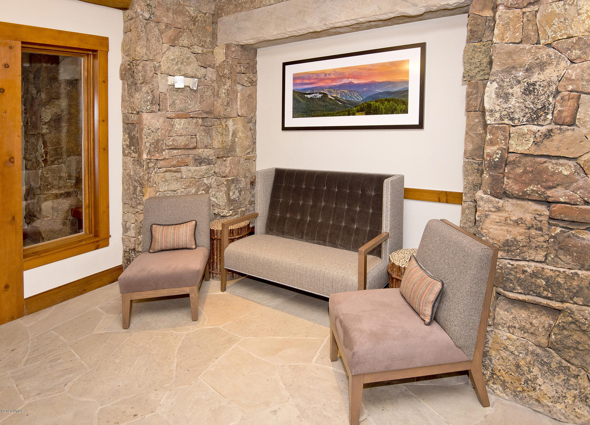 180 Daybreak Ridge Road, Unit 409 Avon, CO 81620 - Photo 32 of 47 a living room with furniture and a painting on the wall