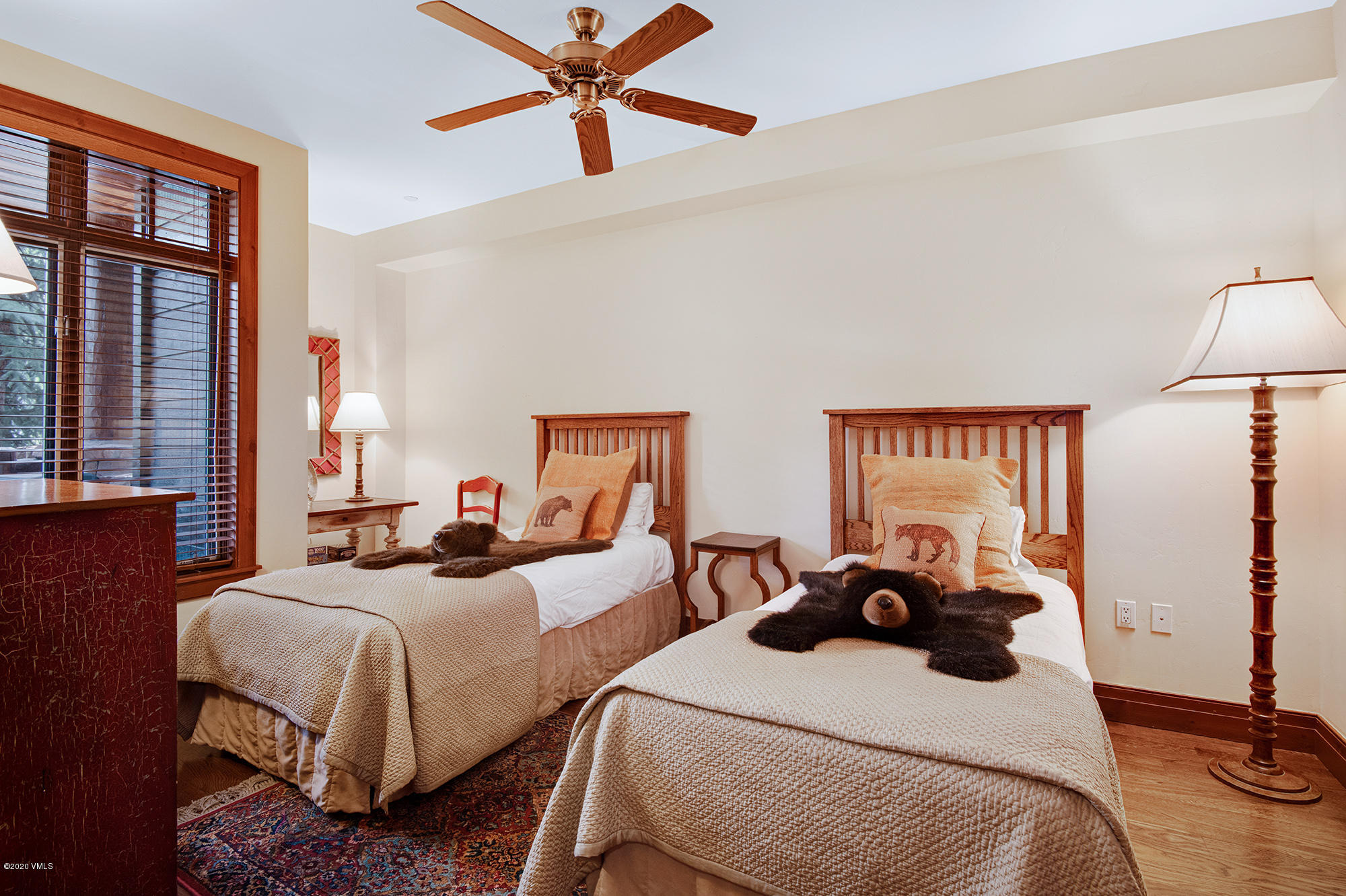 180 Daybreak Ridge Road, Unit 409 Avon, CO 81620 - Photo 4 of 47 a bedroom with two beds and a chandelier