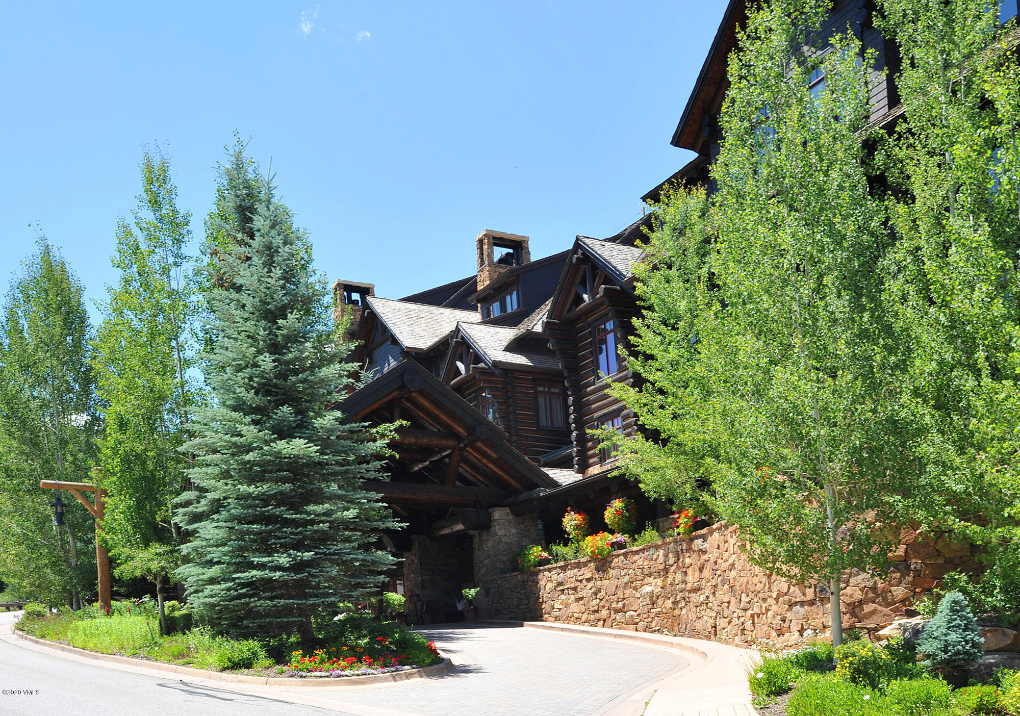 180 Daybreak Ridge Road, Unit 409 Avon, CO 81620 - Photo 9 of 47 a view of a bench in the garden