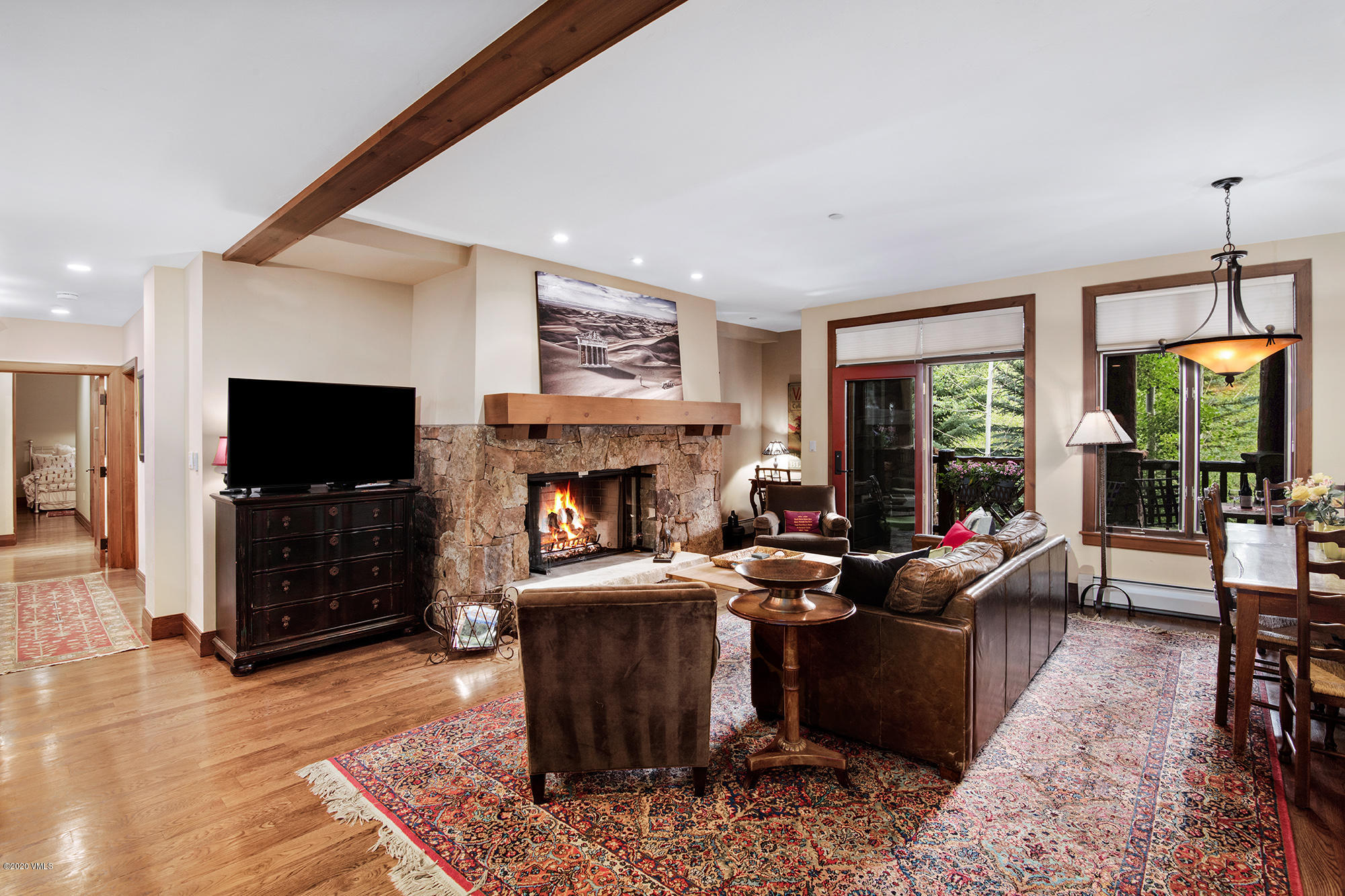 180 Daybreak Ridge Road, Unit 409 Avon, CO 81620 - Photo 10 of 47 a living room with furniture a flat screen tv and a fireplace