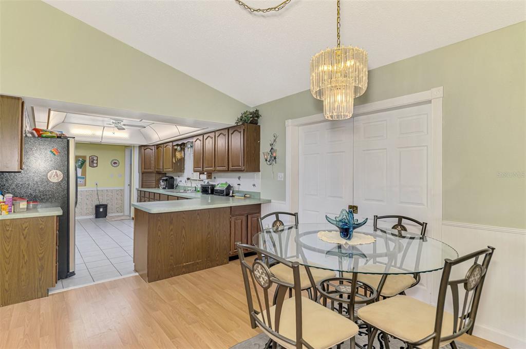 1137 Ponderosa Road Venice, FL 34293 - Photo 12 of 48 a view of a dining room with furniture and wooden floor