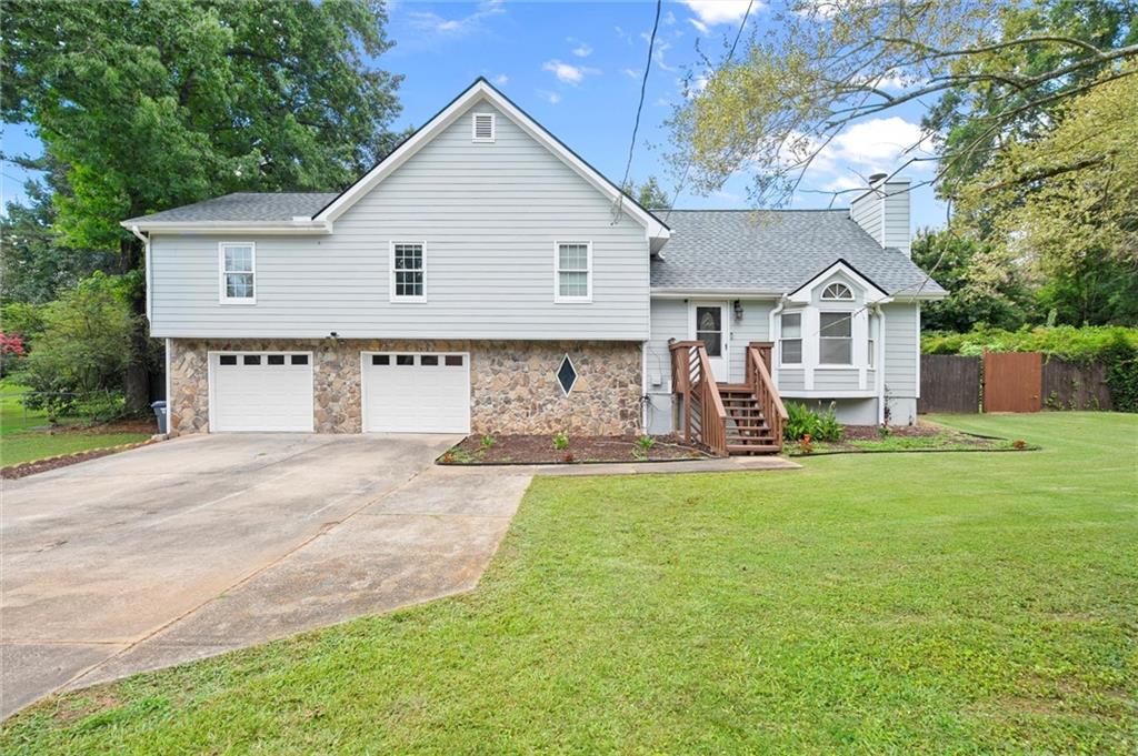 208 Arbour Way Suwanee, GA 30024 - Photo 1 of 1 a view of a house with backyard and a tree