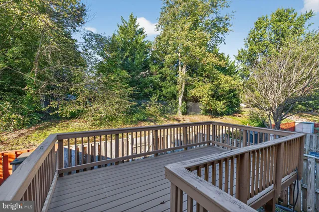 a view of balcony with wooden fence and trees