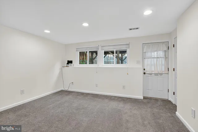 an empty room with windows and closet