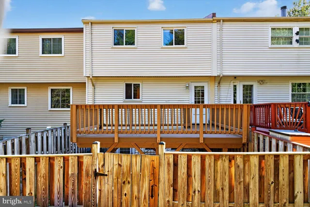 a view of a house with a wooden fence