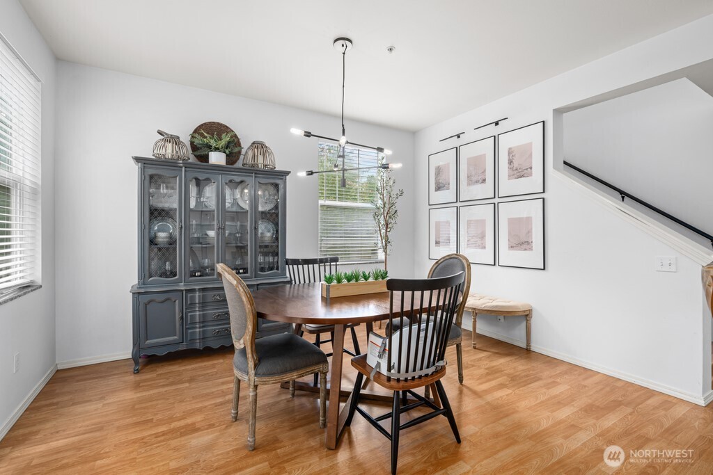 23228 59th Court South Kent, WA 98032 - Photo 12 of 31 a dining room with furniture a chandelier and wooden floor