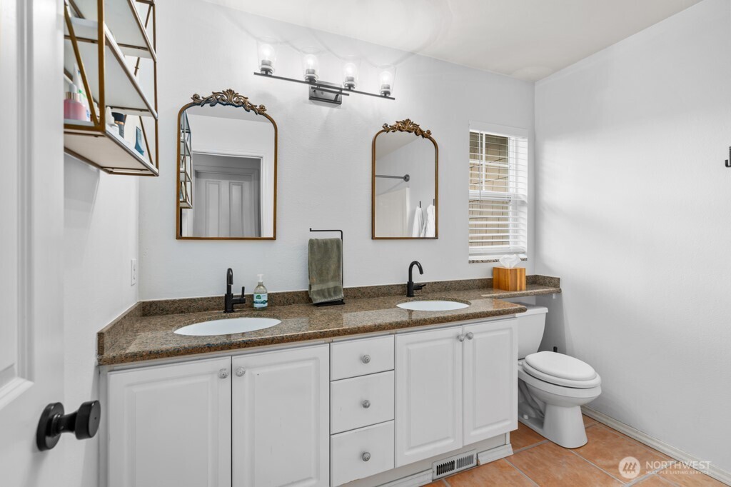 23228 59th Court South Kent, WA 98032 - Photo 17 of 31 a bathroom with double vanity sink a mirror and a toilet