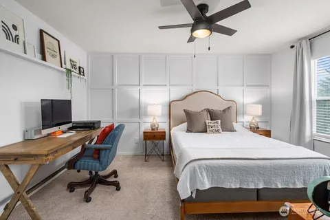 a bedroom with a bed and a desk