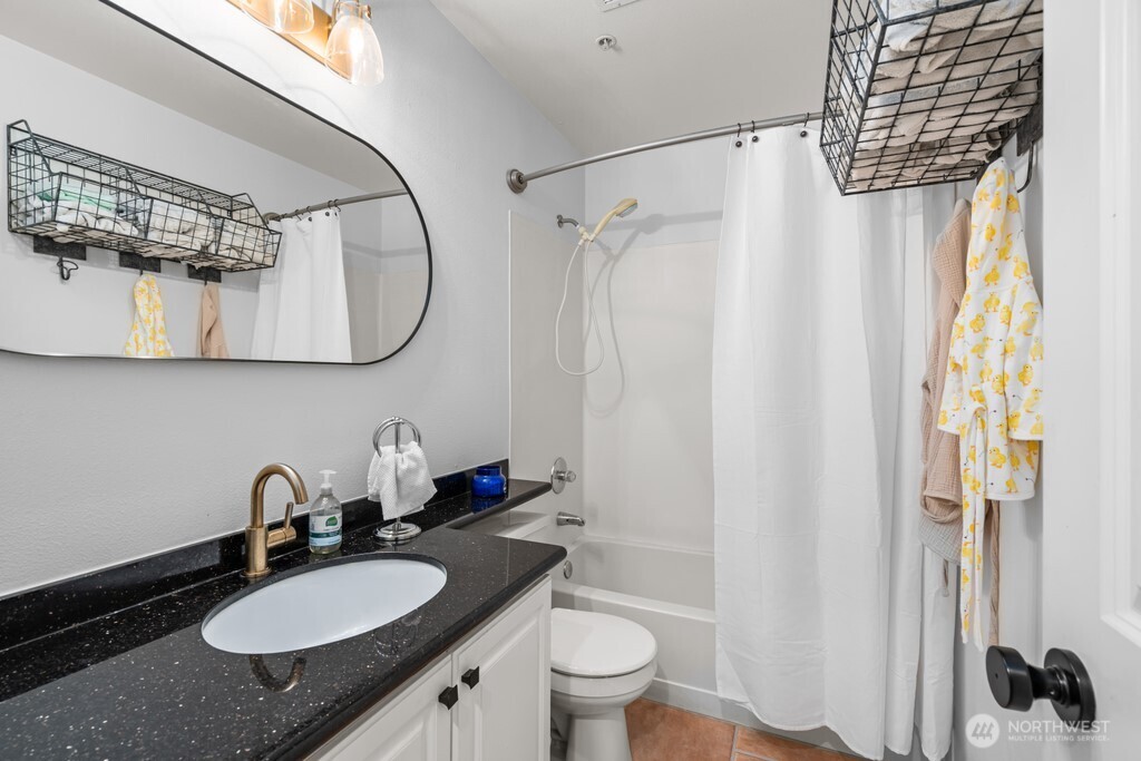 23228 59th Court South Kent, WA 98032 - Photo 23 of 31 a bathroom with a granite countertop sink and a mirror
