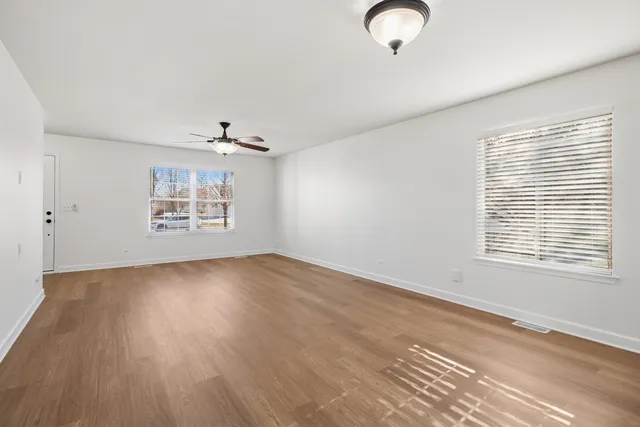 wooden floor in an empty room with a window