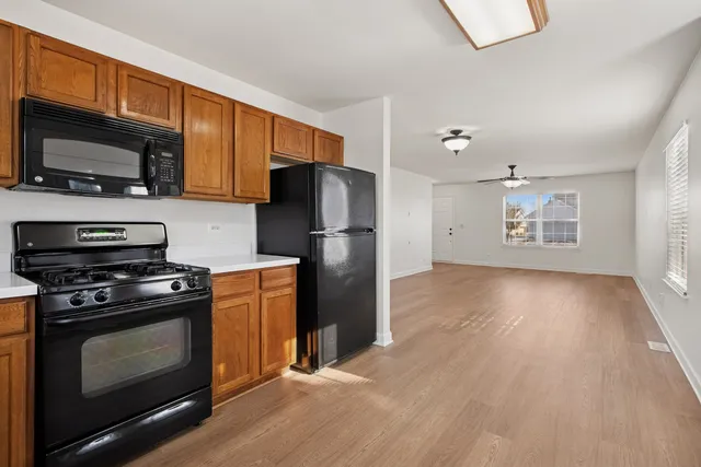 a kitchen with a stove a refrigerator and a microwave