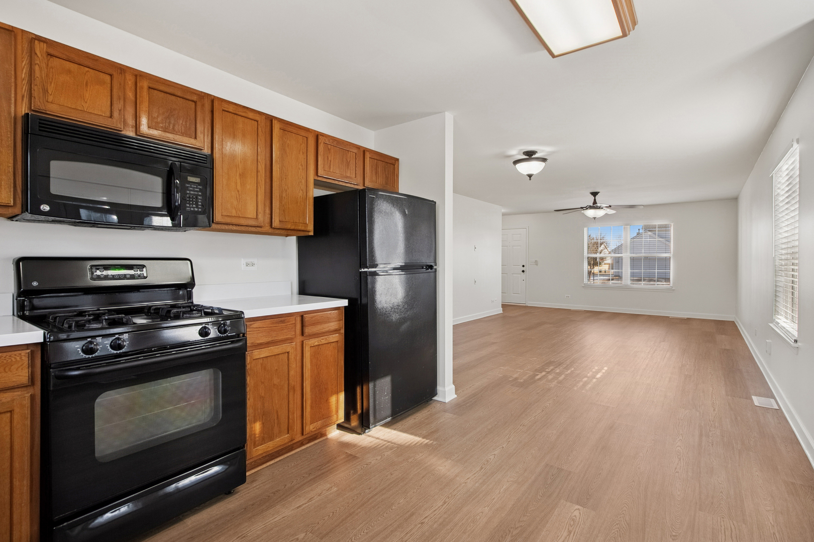 711 Osbron Street Plano, IL 60545 - Photo 8 of 20 a kitchen with a stove a refrigerator and a microwave