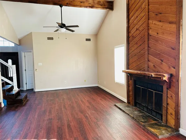 a view of a livingroom with wooden floor and a window