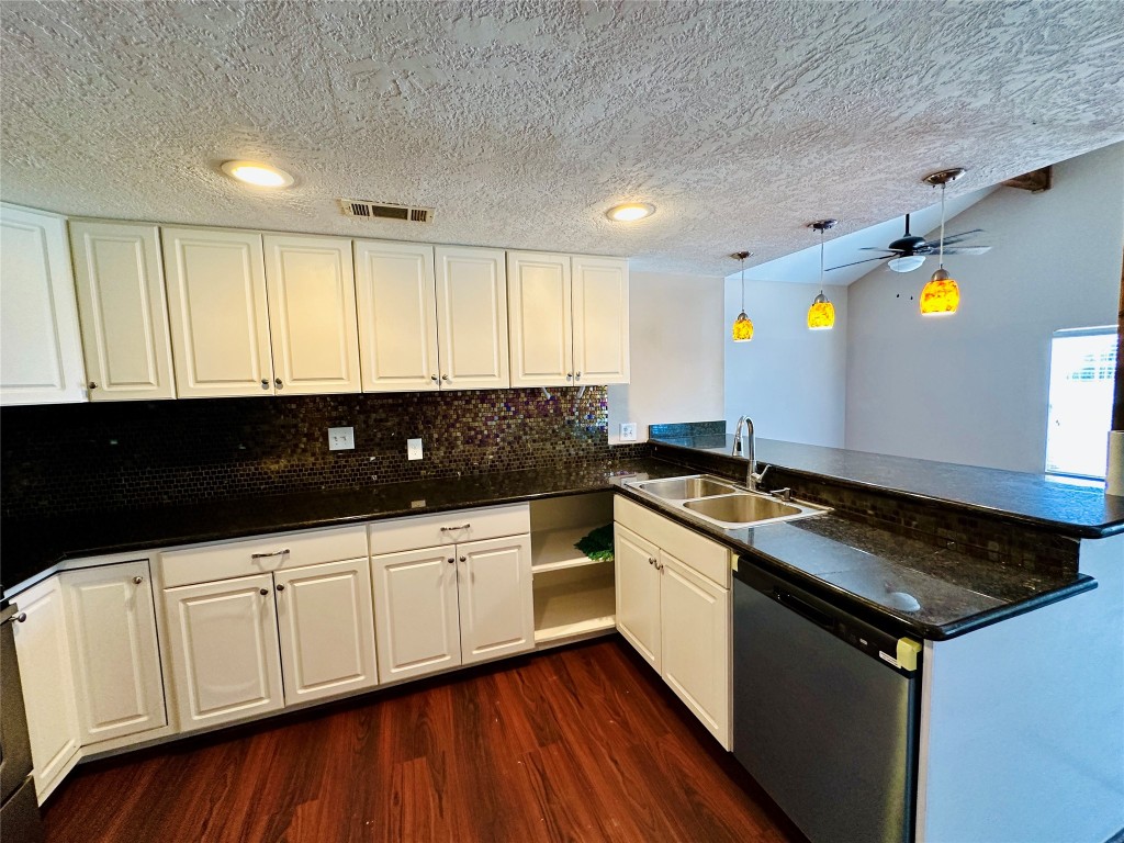 25417 Highway 6 Hempstead, TX 77445 - Photo 20 of 48 a kitchen with granite countertop white cabinets and black appliances