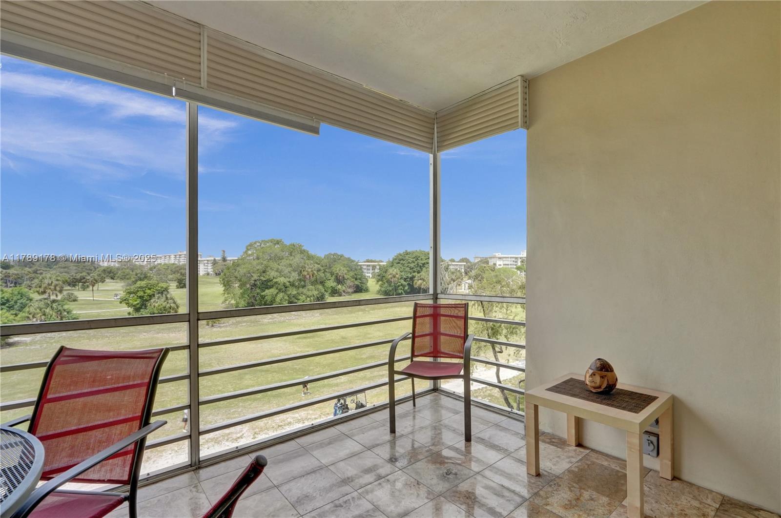 2671 South Course Drive, Unit 409 Pompano Beach, FL 33069 - Photo 11 of 45 a view of a two chair in the balcony