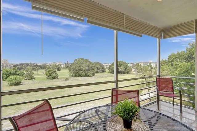 a view of a chairs and table in the balcony