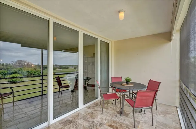 a view of a two chairs and table in the balcony