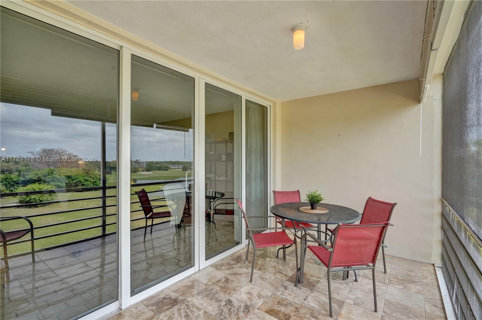 2671 South Course Drive, Unit 409 Pompano Beach, FL 33069 - Photo 14 of 45 a view of a two chairs and table in the balcony