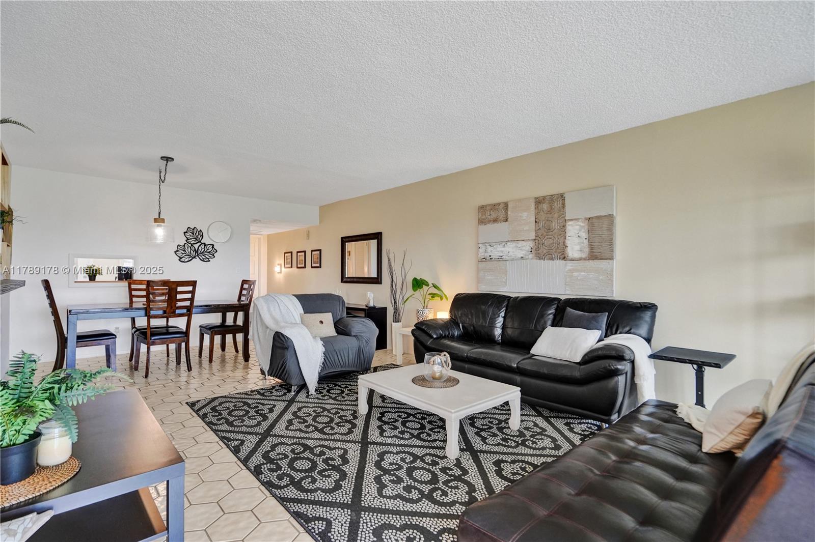 2671 South Course Drive, Unit 409 Pompano Beach, FL 33069 - Photo 16 of 45 a living room with furniture and a rug
