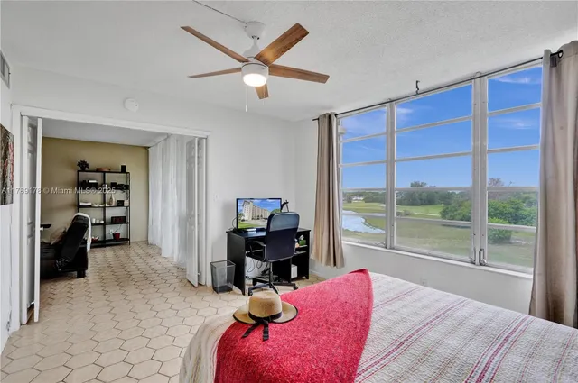 a bedroom with a bed and a large window