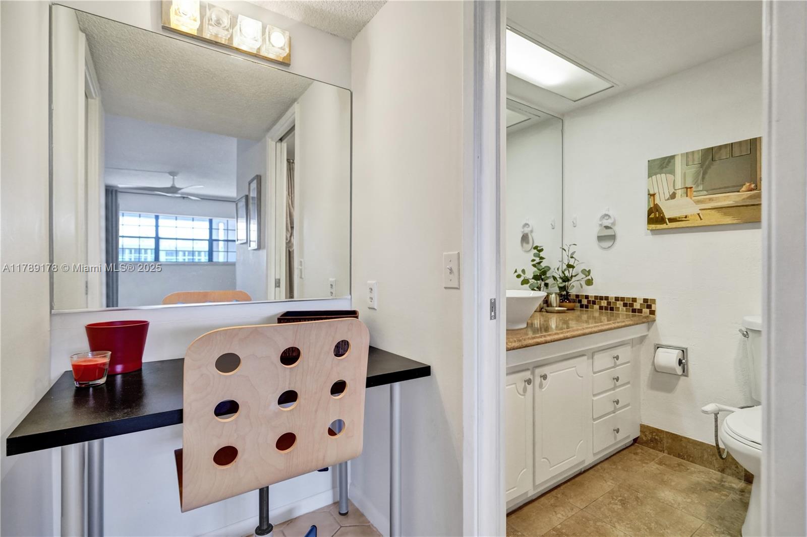 2671 South Course Drive, Unit 409 Pompano Beach, FL 33069 - Photo 29 of 45 a bathroom with a sink and a mirror
