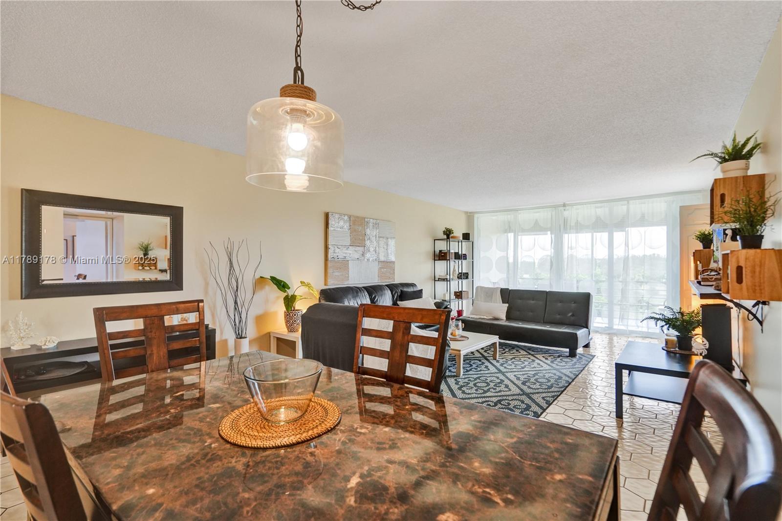 2671 South Course Drive, Unit 409 Pompano Beach, FL 33069 - Photo 3 of 45 a living room with furniture a piano and a window