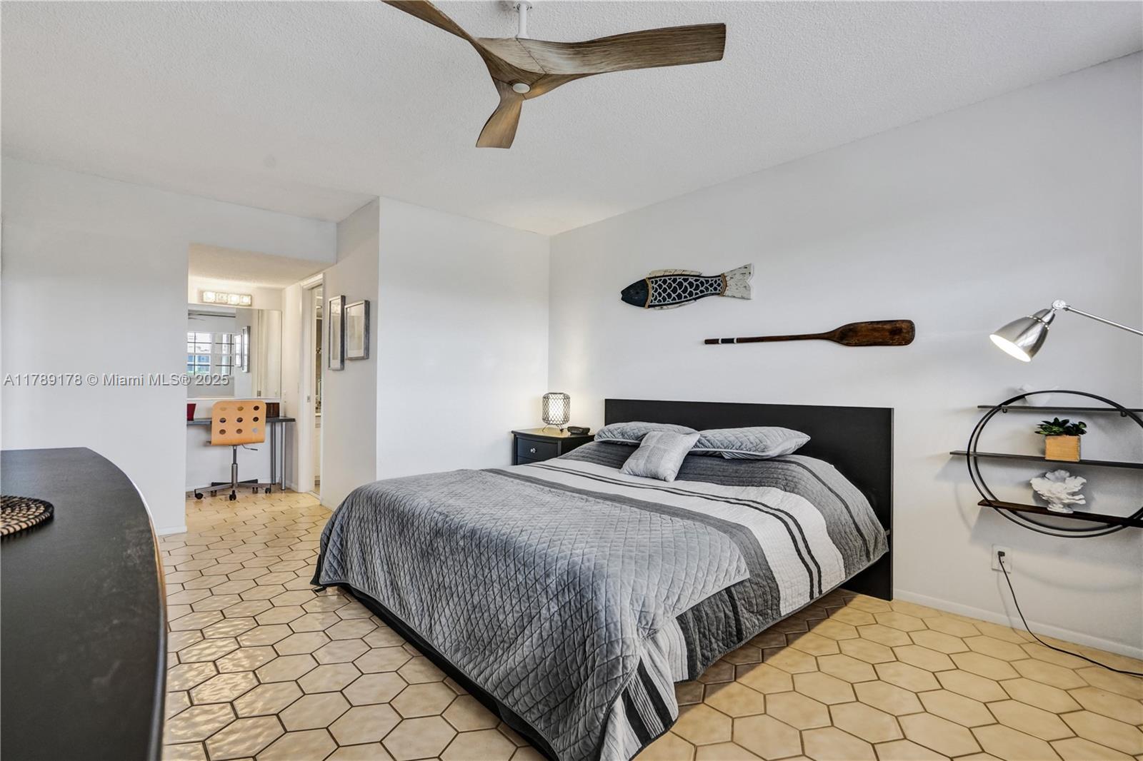 2671 South Course Drive, Unit 409 Pompano Beach, FL 33069 - Photo 31 of 45 a bedroom with double bed and a night stand