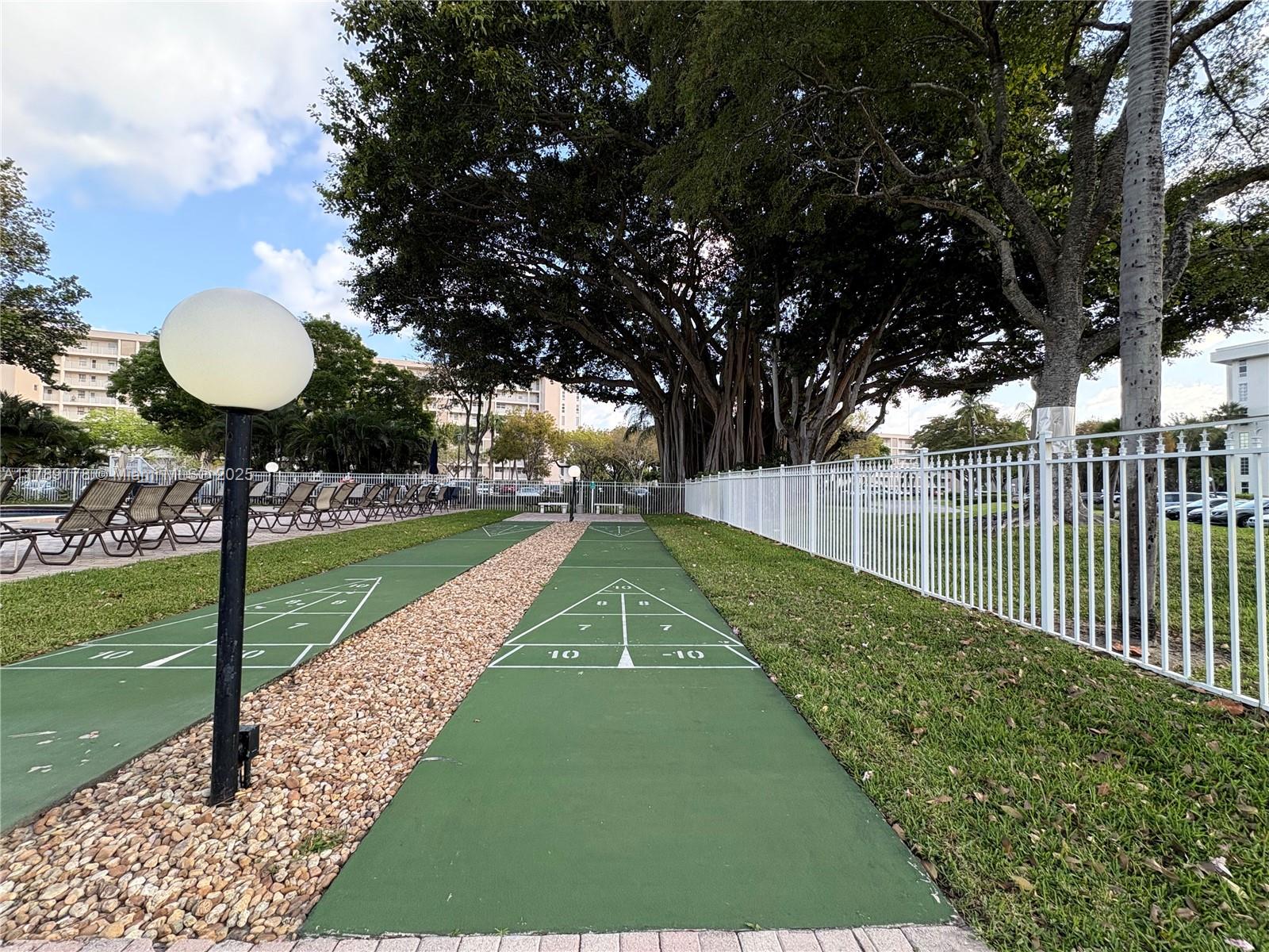 2671 South Course Drive, Unit 409 Pompano Beach, FL 33069 - Photo 39 of 45 a view of a backyard with a garden