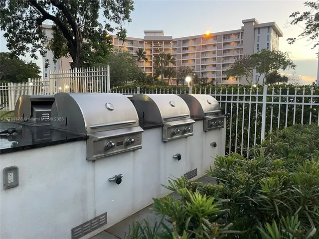 a view of roof deck with chairs and potted plants