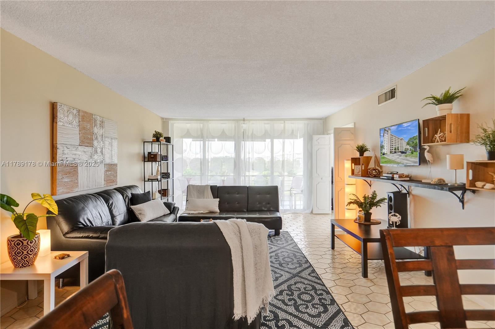 2671 South Course Drive, Unit 409 Pompano Beach, FL 33069 - Photo 4 of 45 a bedroom with a bed and wooden floor