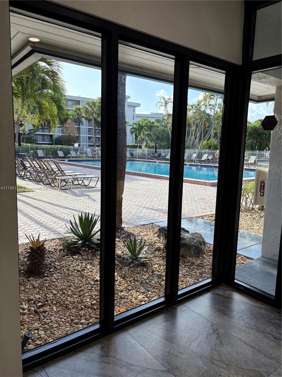 2671 South Course Drive, Unit 409 Pompano Beach, FL 33069 - Photo 41 of 45 a view of a glass door and a balcony