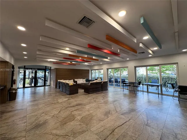 a big room with lots of furniture and a large window