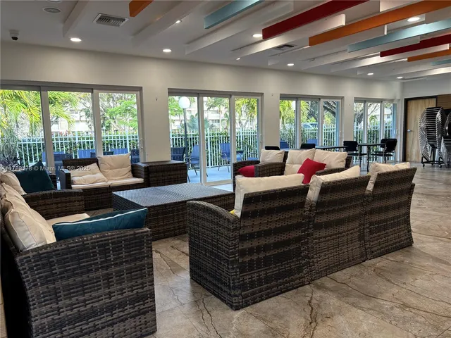 a living room with furniture and large windows