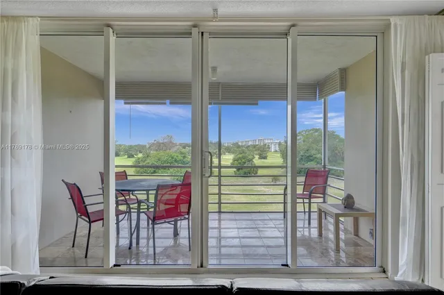 a view of a room with a floor to ceiling window and an outdoor view