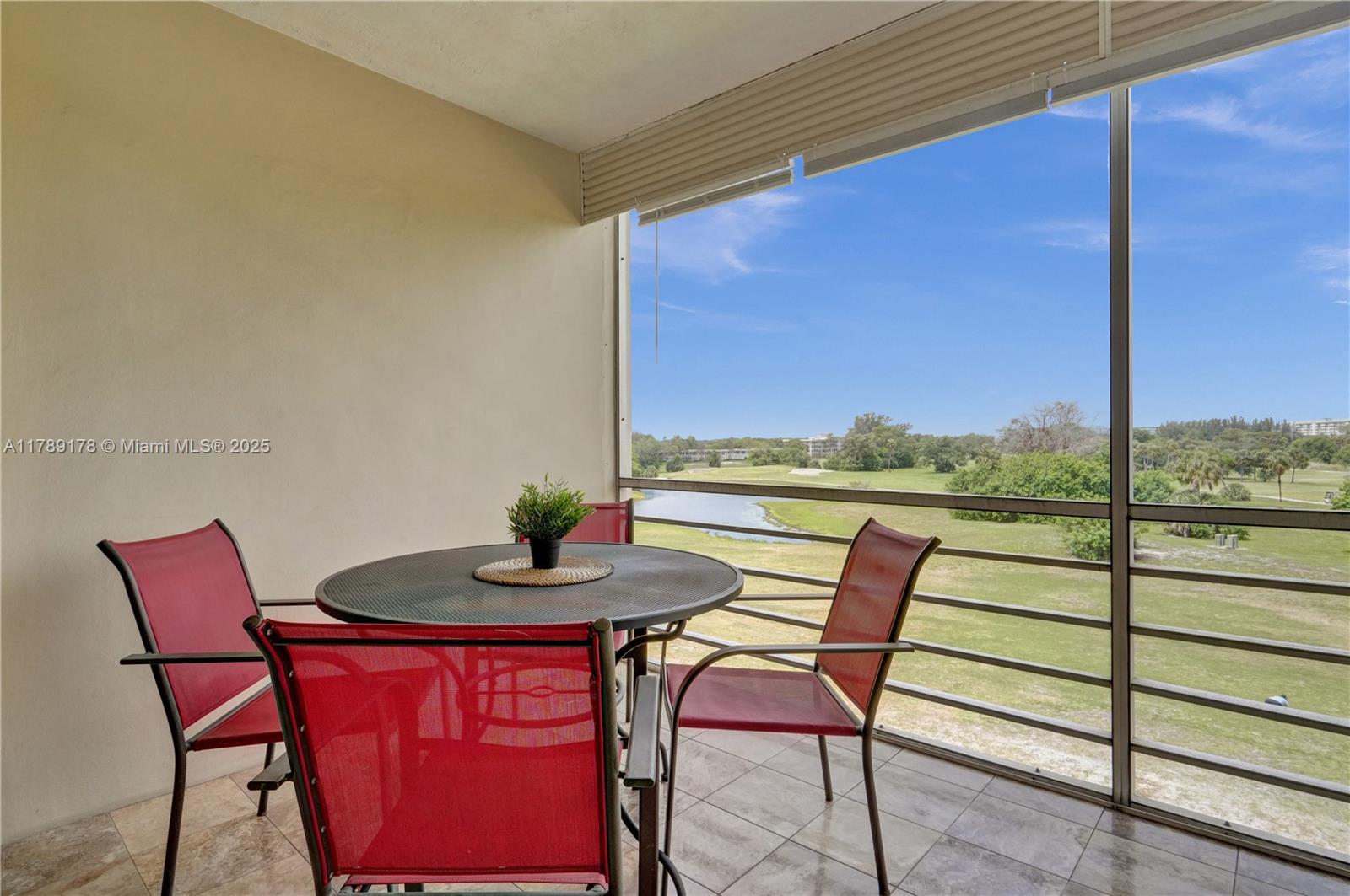 2671 South Course Drive, Unit 409 Pompano Beach, FL 33069 - Photo 10 of 45 a view of a chairs and table in the balcony