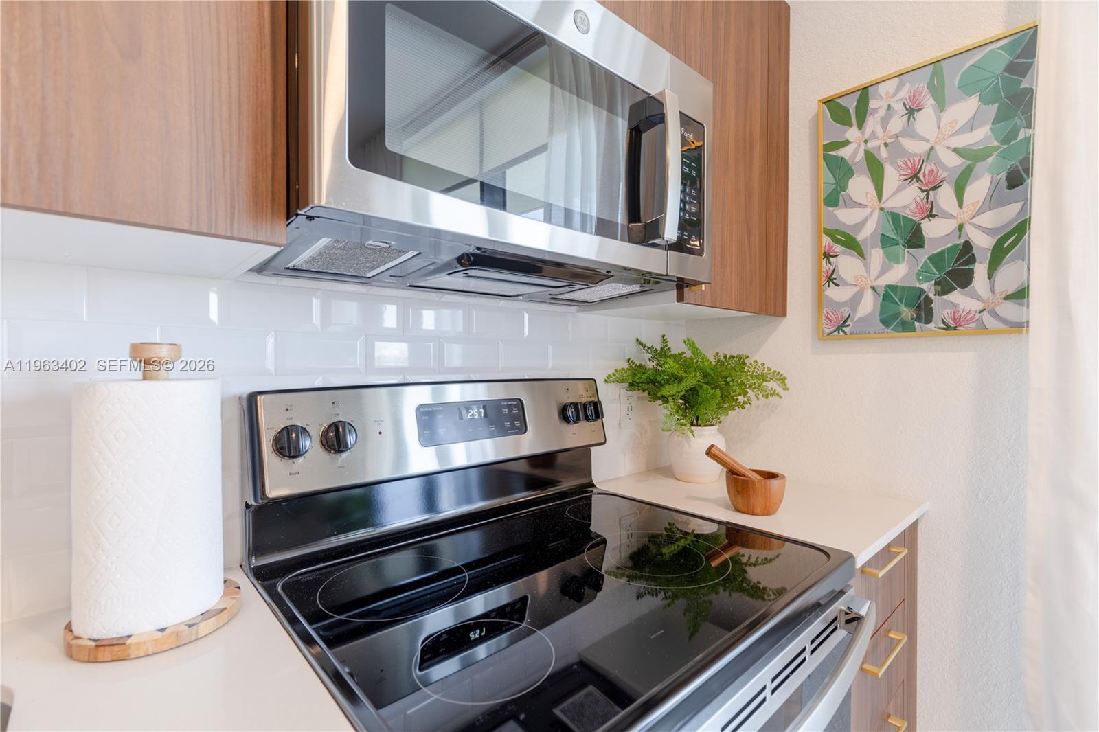 1005 Spring Garden Road, Unit 505 Miami, FL 33136 - Photo 6 of 35 a stove top oven sitting inside of a kitchen