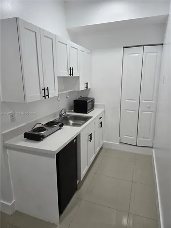 a kitchen with a sink stove and cabinets