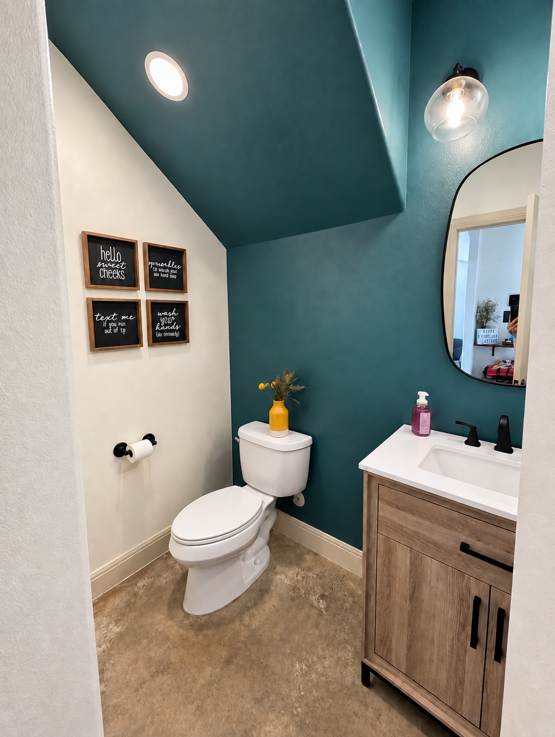 2316 Thornton Road, Unit B Austin, TX 78704 - Photo 10 of 25 An under-stairs powder room maximizes space with a vaulted ceiling and a wood-toned vanity.