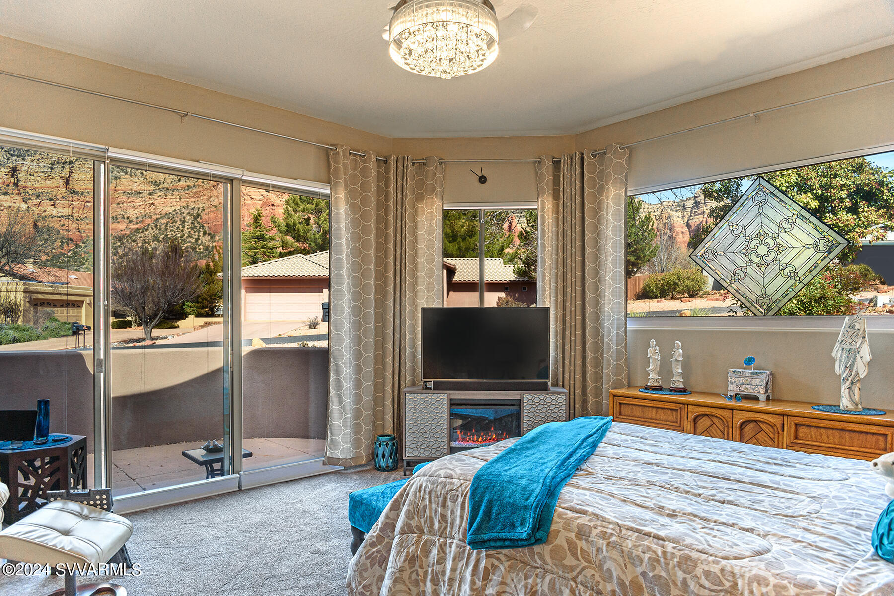 25 Ranch Road Sedona, AZ 86336 - Photo 12 of 36 a bedroom with a bed and a flat tv screen on the dresser