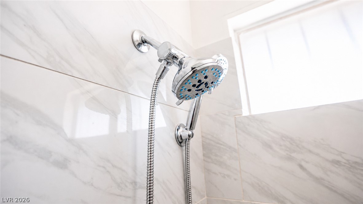 2870 South Sandhill Road Las Vegas, NV 89121 - Photo 38 of 64 Marble-patterned tiled shower with a dual head system.