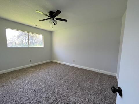 18690 Reeds Creek Road Red Bluff, CA 96080 - Photo 21 of 23 an empty room with a window and a ceiling fan