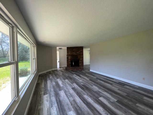 18690 Reeds Creek Road Red Bluff, CA 96080 - Photo 8 of 23 a view of empty room with wooden floor and fireplace