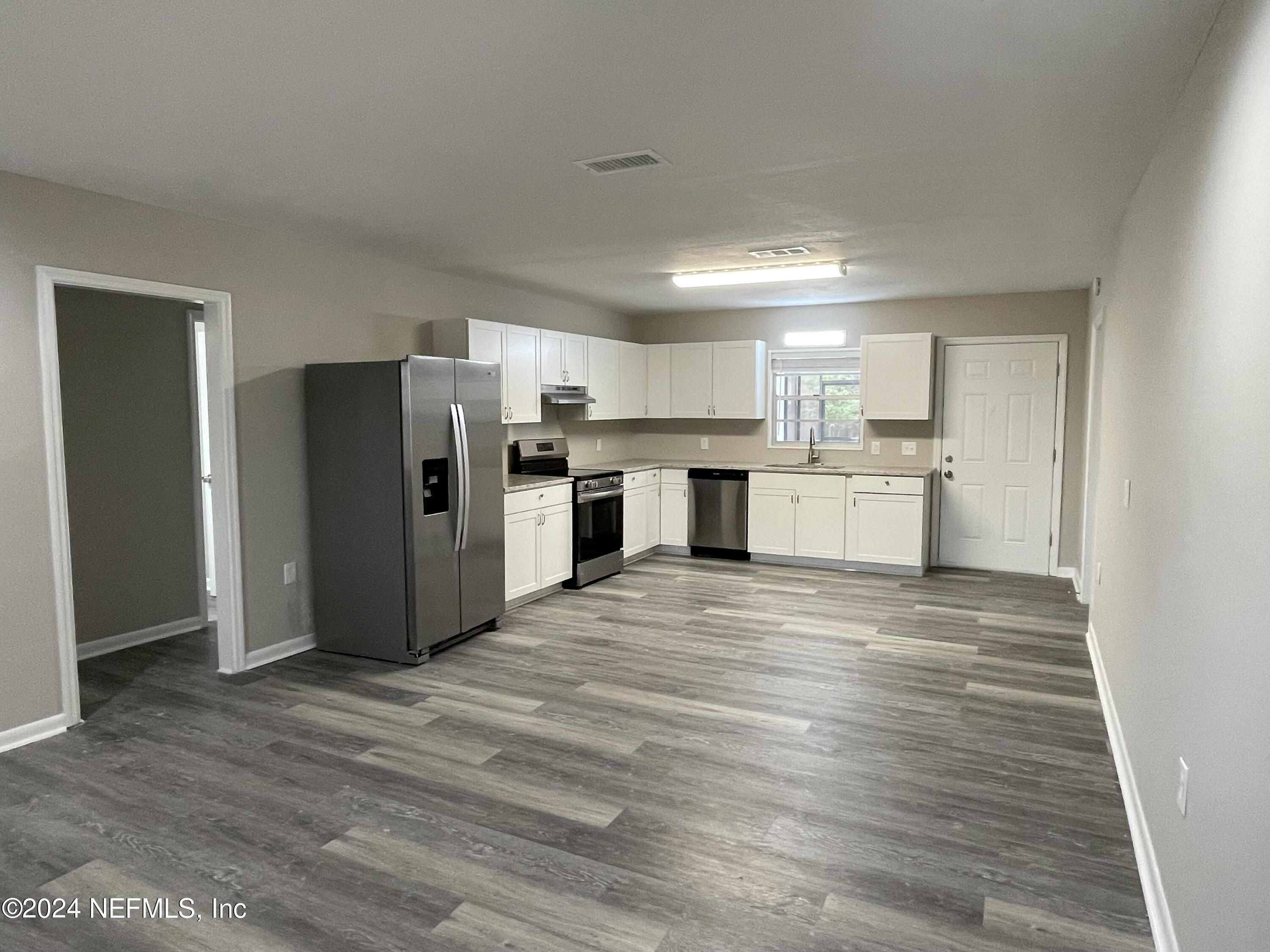 830 Gerona Road St. Augustine, FL 32086 - Photo 11 of 27 a view of a kitchen with a sink refrigerator and wooden floor