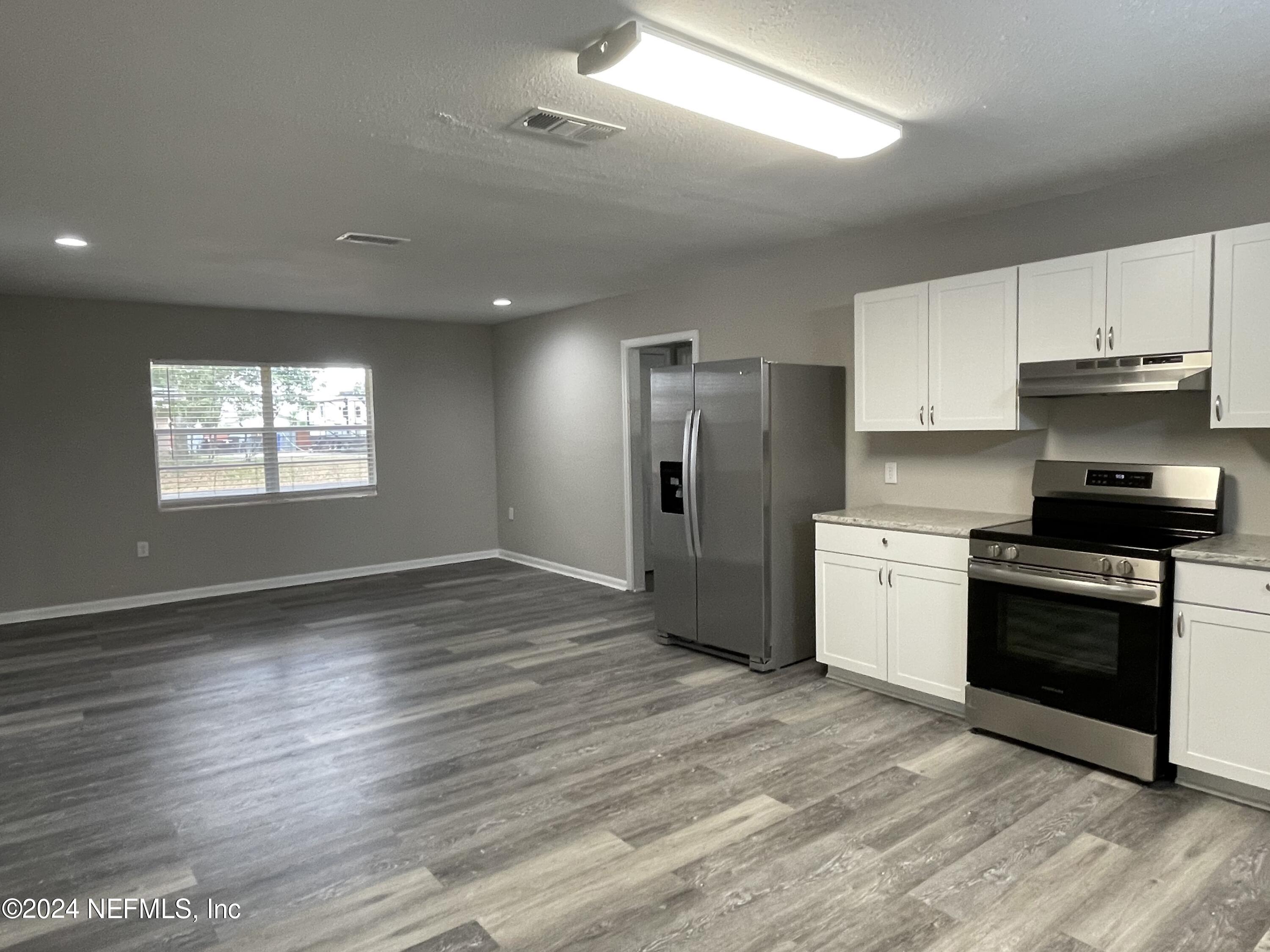 830 Gerona Road St. Augustine, FL 32086 - Photo 12 of 27 a kitchen with granite countertop a refrigerator stove and oven